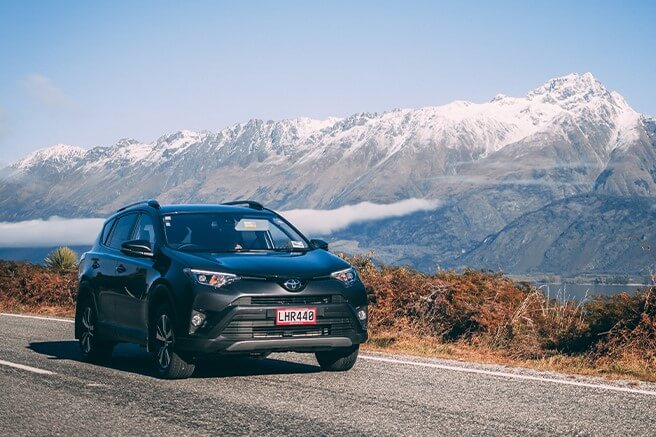 GO Rentals car in the road with the mountains in the background
